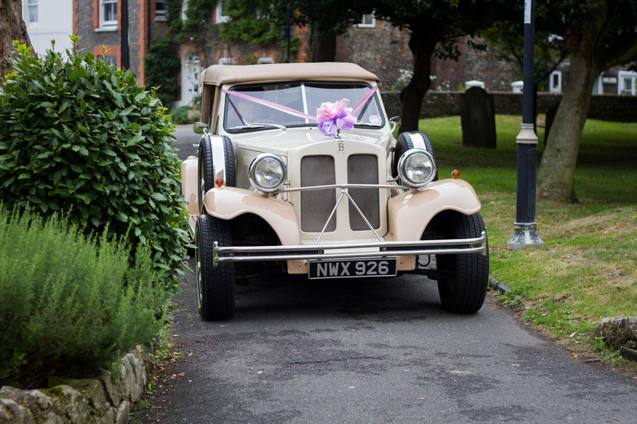 bride arriving in church in vintage car